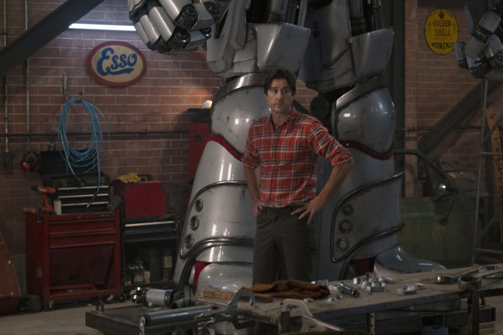 Pat with his Iron S.T.R.I.P.E. robot he built to combat bad guys.