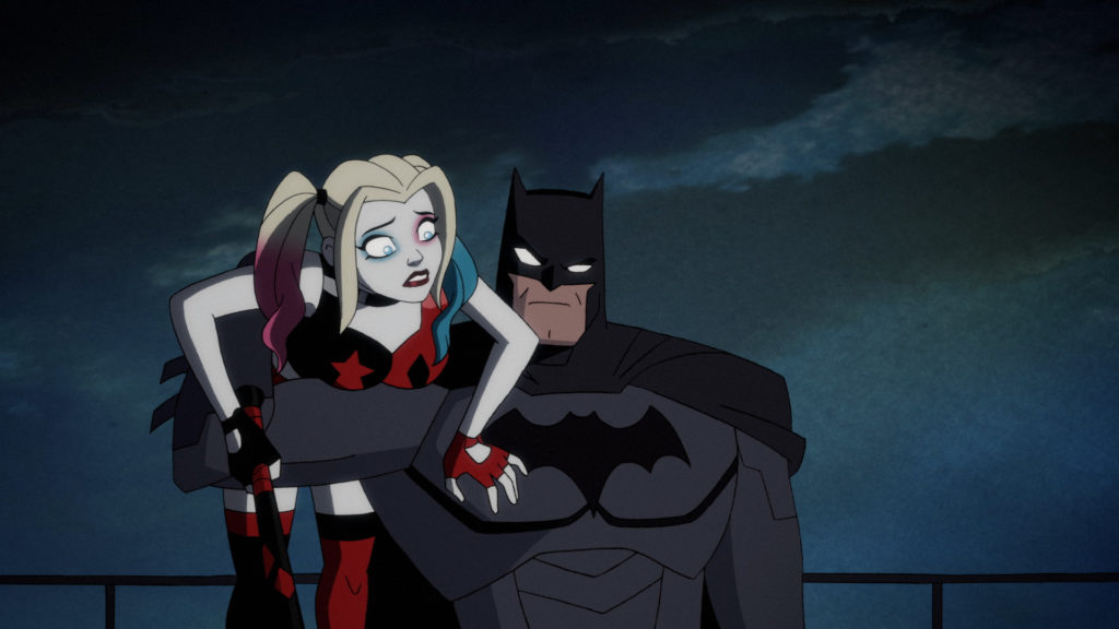 A recently-rescued Harley Quinn is being held under one arm by Batman.