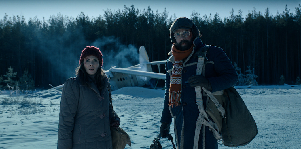 Joyce and Murray look on in Alaska after a plane crash in Stranger Things Season 4