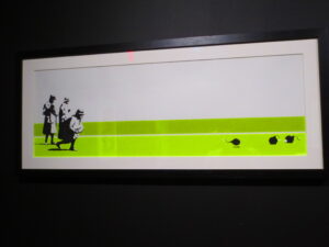 Bomb Middle England by Banksy. Silkscreen print of three old ladies playing bowls on the green in the English countryside but replaced with lit cannonballs 