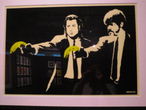 Pulp Fiction by Banksy. Screenprint of Pulp Fiction’s protagonists Vincent and Julius side by side, holding bananas instead of pistols