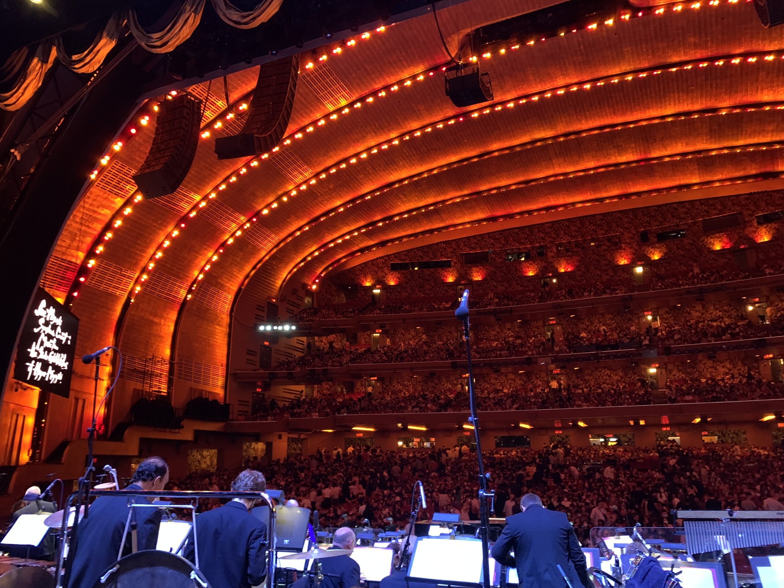 view from the stage of a sold out radio city music hall audience