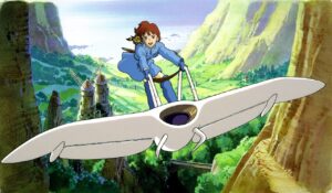 a girl in a blue dress riding a white glider across a green valley