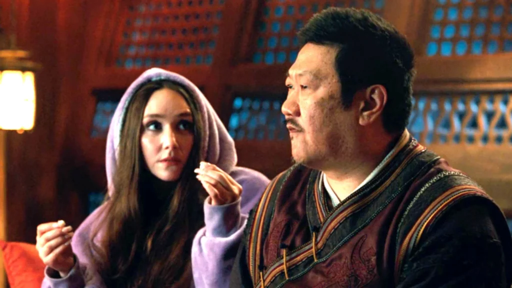 Madisynn in a purple snuggie talks with Wong 