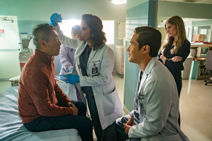 Ben and Addison watch as Dr. Sandra attends to Louis in the ER