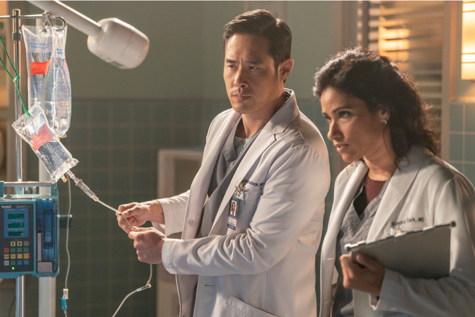 Ben and Dr. Sandra look concerned in an operating room 