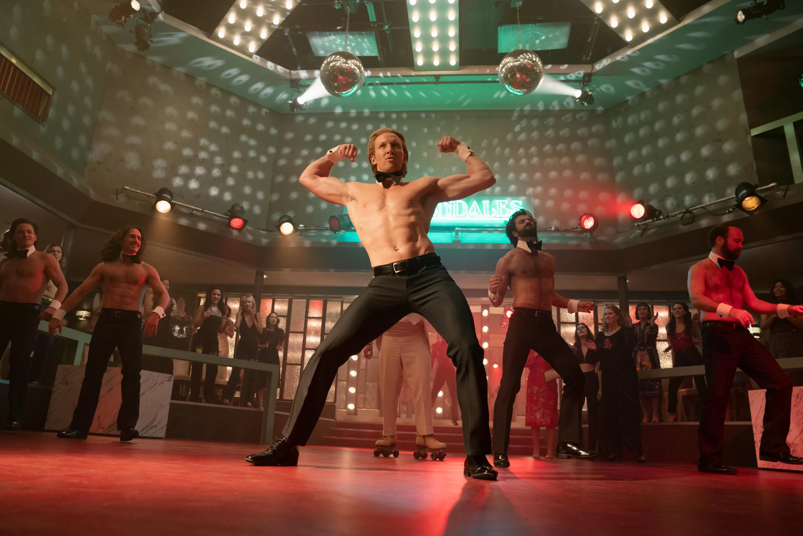 Male burlesque dancers dance while flexing their biceps in Welcome to Chippendales episode 4