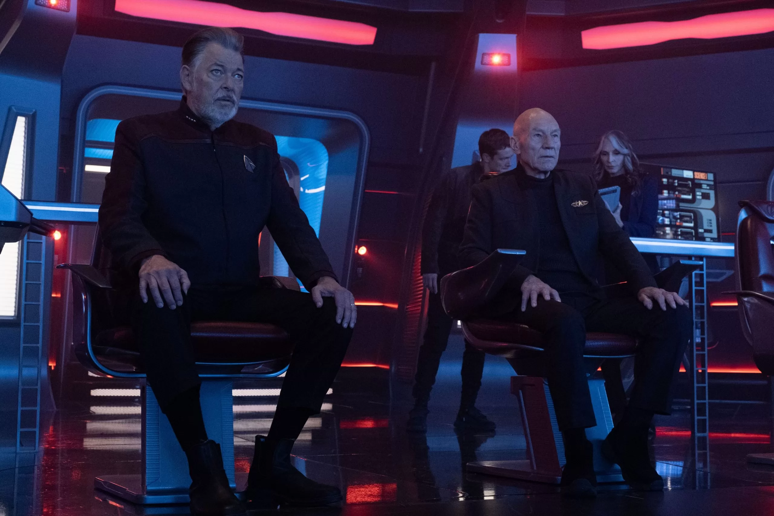 Picard and Riker on the bridge with Beverly and Jack Crusher in the background
