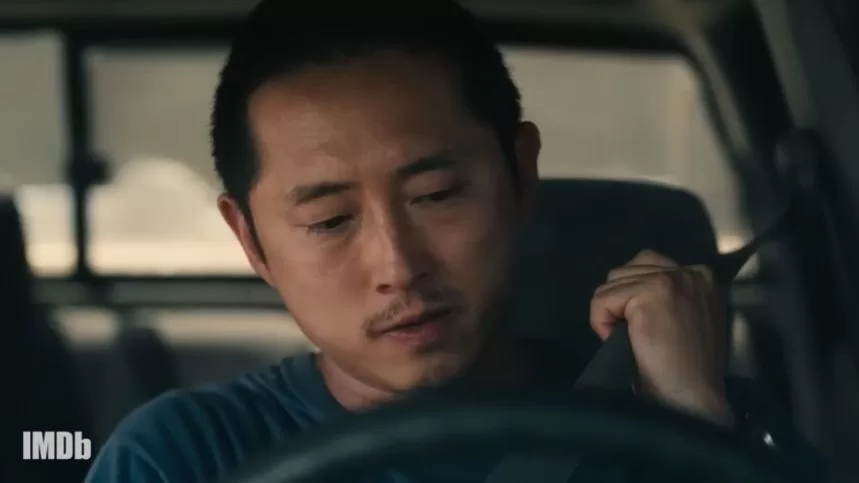 Image of Danny from Beef (2023) putting on his seatbelt in the driver's seat of a car